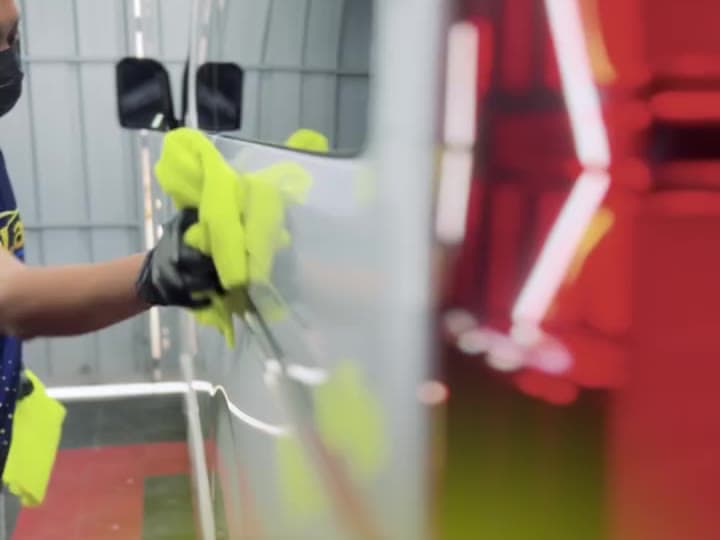 Detailer drying paint with a microfiber towel